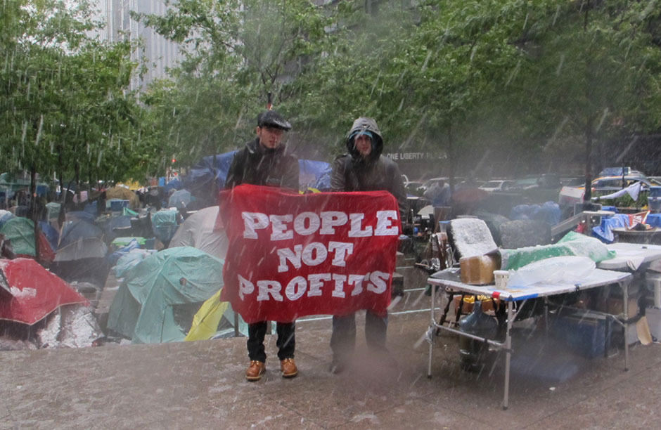 Two demonstrators at "Occupy Wall Street" stand their ground on Saturday October 29 as a Nor'easter slams Liberty Park with snow, sleet, thunder, lightening and gale-force winds. All images by Nicole Davis.