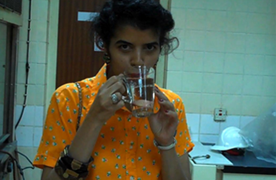 The Author, Hayfa Matar, tests a sample of water at the Ras Abu Jarjur desalination plant in Bahrain.