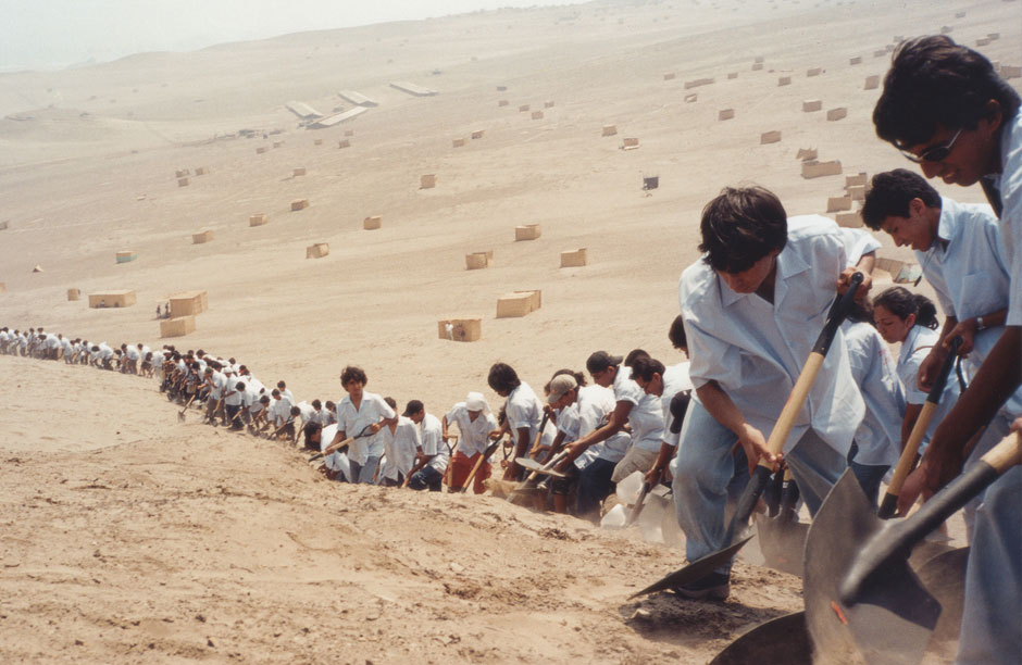 Students from the University of Lima shoveling sand in the Ventanilla desert just outside of Lima as part of an art intervention organized by artist Francis Alÿs titled "When Faith Moves Mountains" (April 11, 2002)