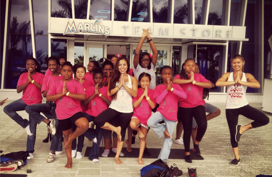 Marsiol Tamez (center) teaching yoga at an outreach event at the new Florida Marlins stadium.